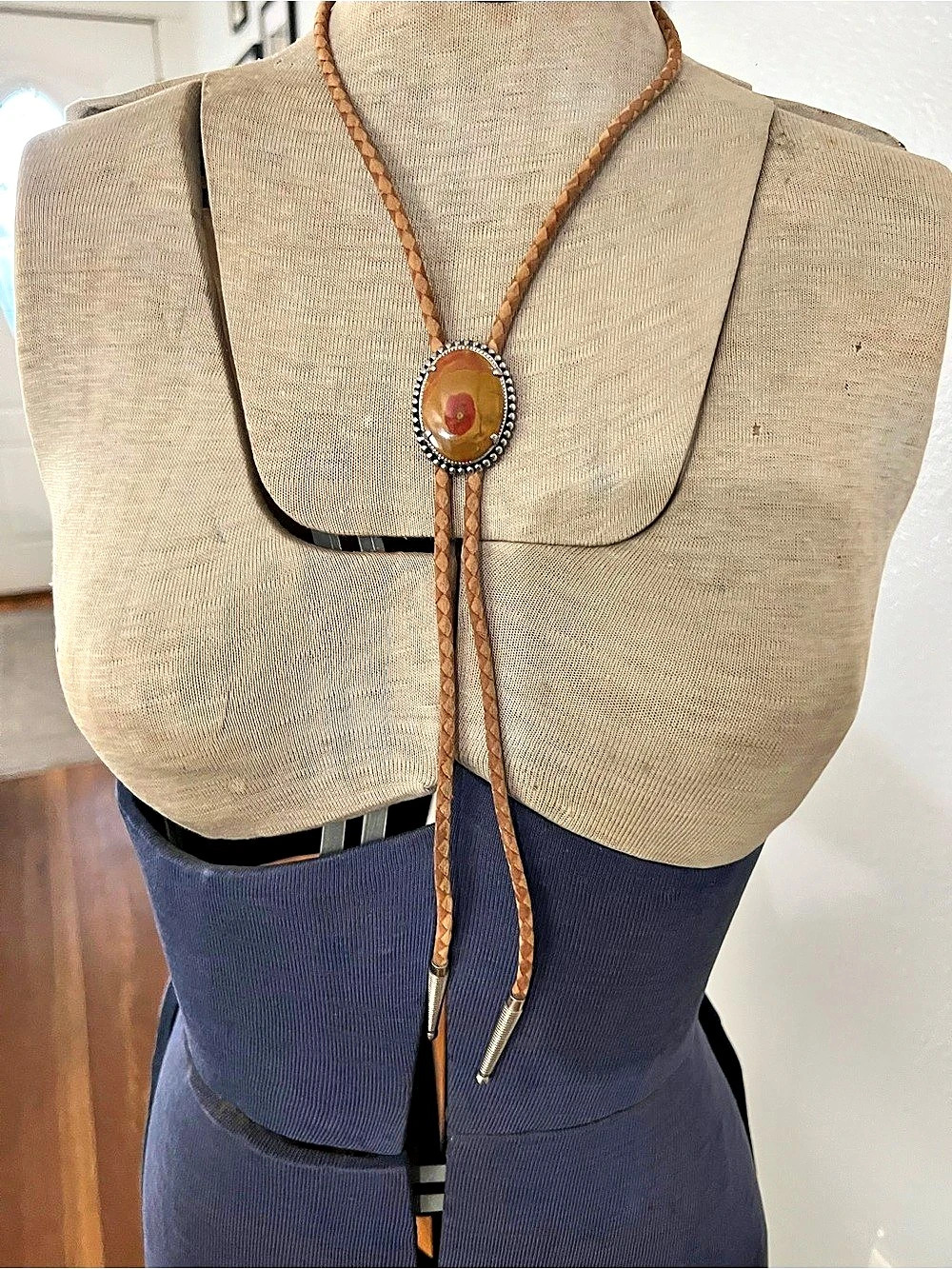 western-style bolo tie featuring a smooth, multicolored agate